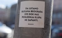 a sticker on a pole on a city street