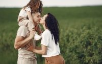 A heartwarming family moment captured in a field, highlighting love and togetherness.