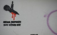 Graffiti of a microphone with dripping red paint